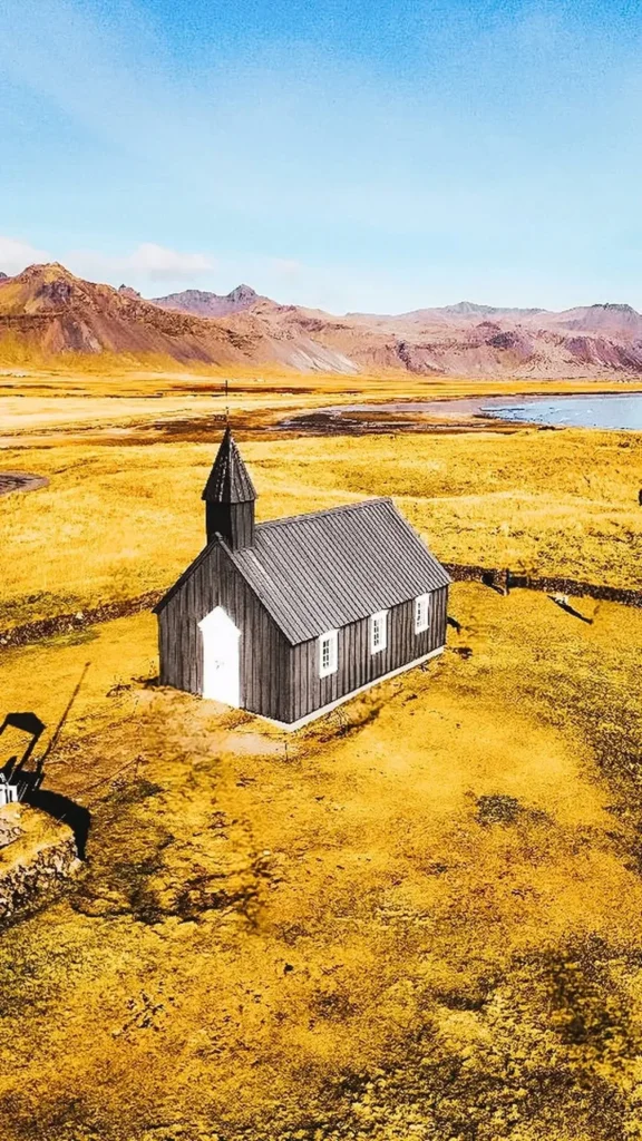 The black church of Budir among golden grass