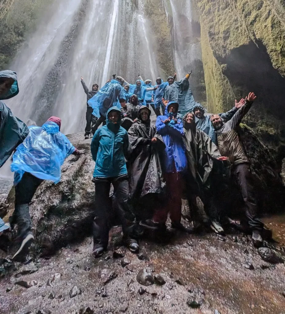 In rain ponchos inside the waterfall canyon