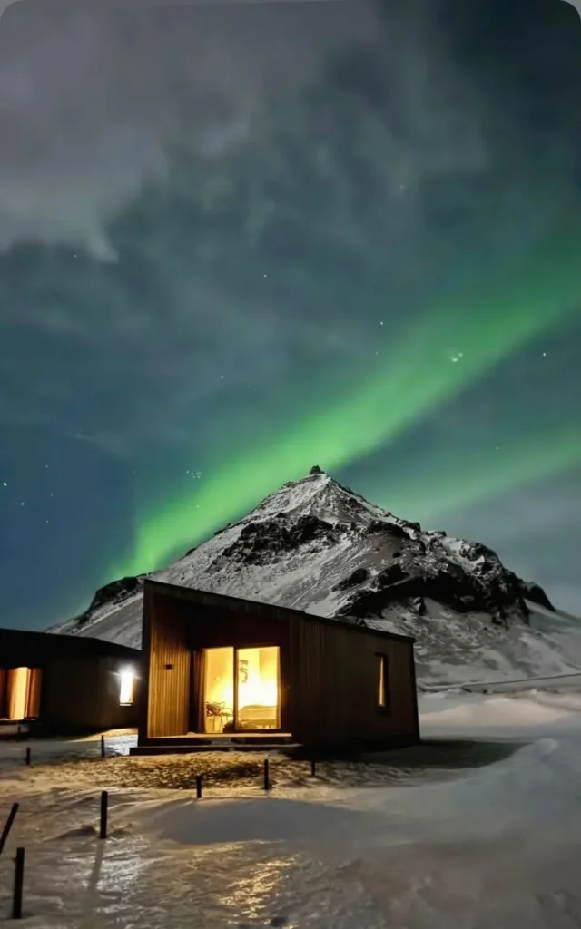 Northern lights over our cabins in Arnarstapi